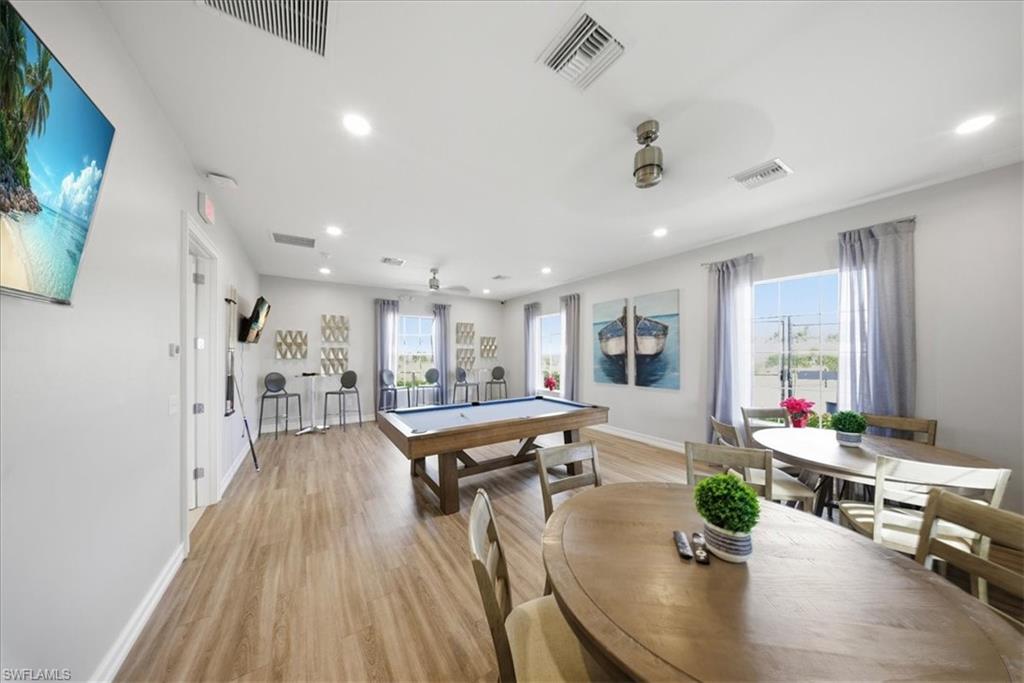 1074 Enbrook Loop Naples, FL 34114 - Photo 29 of 36 a living room with furniture and a flat screen tv