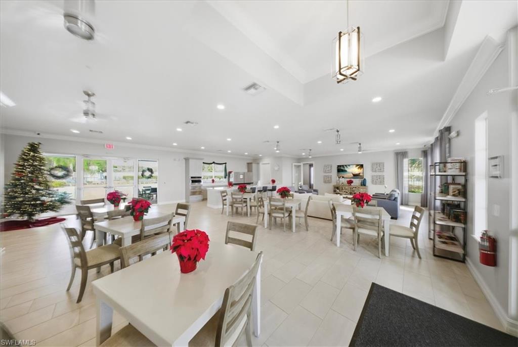 1074 Enbrook Loop Naples, FL 34114 - Photo 32 of 36 a living room with lots of furniture and a kitchen view
