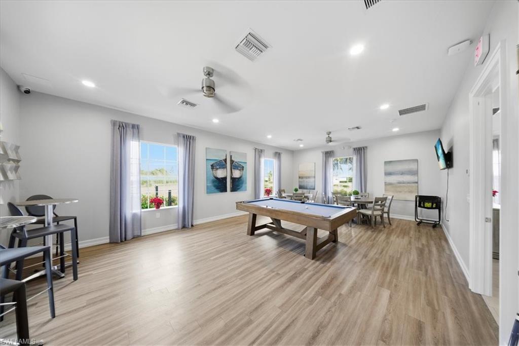 1074 Enbrook Loop Naples, FL 34114 - Photo 33 of 36 a living room with furniture and wooden floor