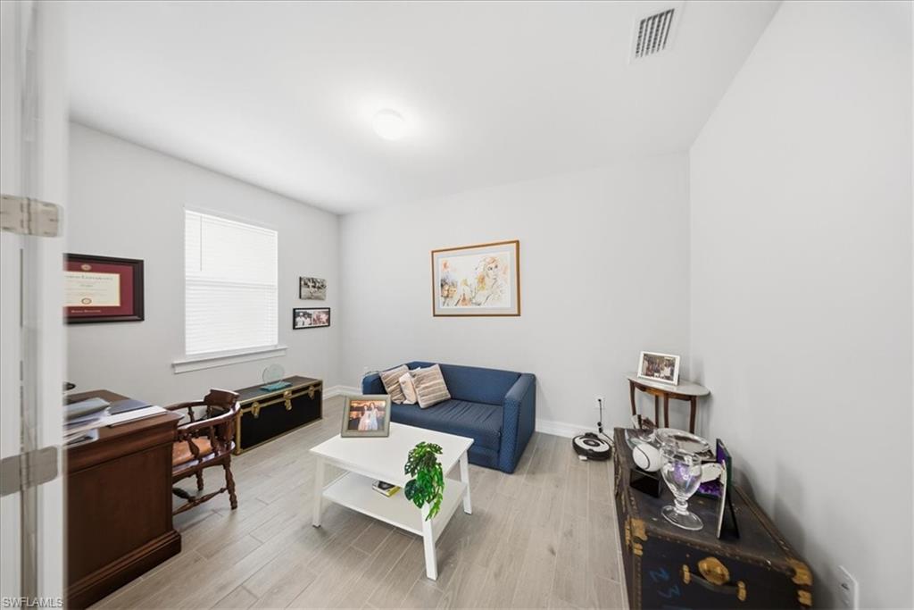 1074 Enbrook Loop Naples, FL 34114 - Photo 7 of 36 a living room with furniture and a flat screen tv