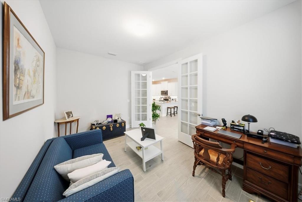 1074 Enbrook Loop Naples, FL 34114 - Photo 8 of 36 a living room with furniture and a mirror