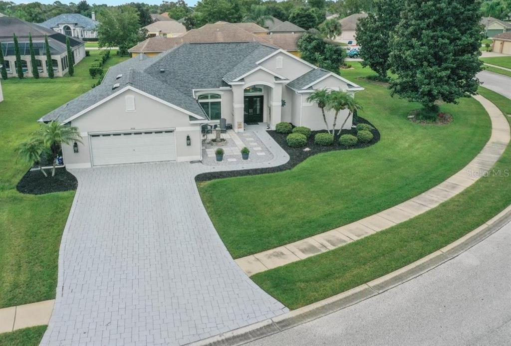 3456 Hanging Moss Loop Spring Hill, FL 34609 - Photo 2 of 81 a front view of a house with garden