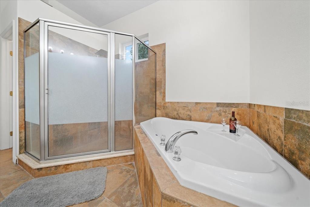 3456 Hanging Moss Loop Spring Hill, FL 34609 - Photo 37 of 81 a bathroom with a tub and shower