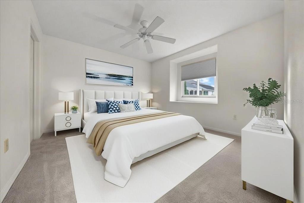 3456 Hanging Moss Loop Spring Hill, FL 34609 - Photo 46 of 81 a bedroom with a large bed and a chandelier