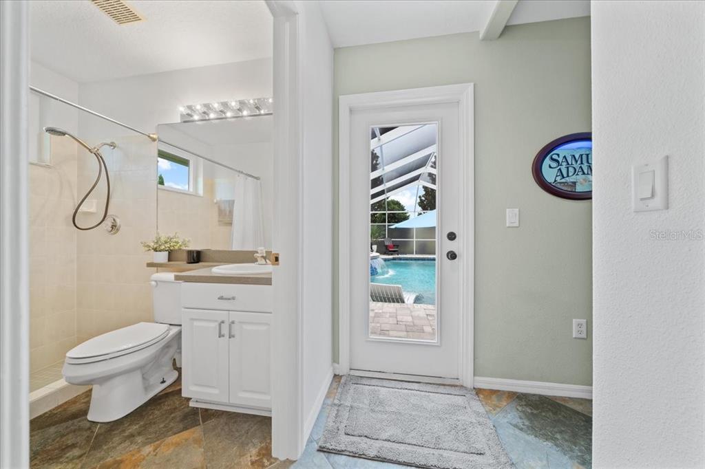 3456 Hanging Moss Loop Spring Hill, FL 34609 - Photo 49 of 81 a bathroom with a granite countertop sink a toilet and a shower