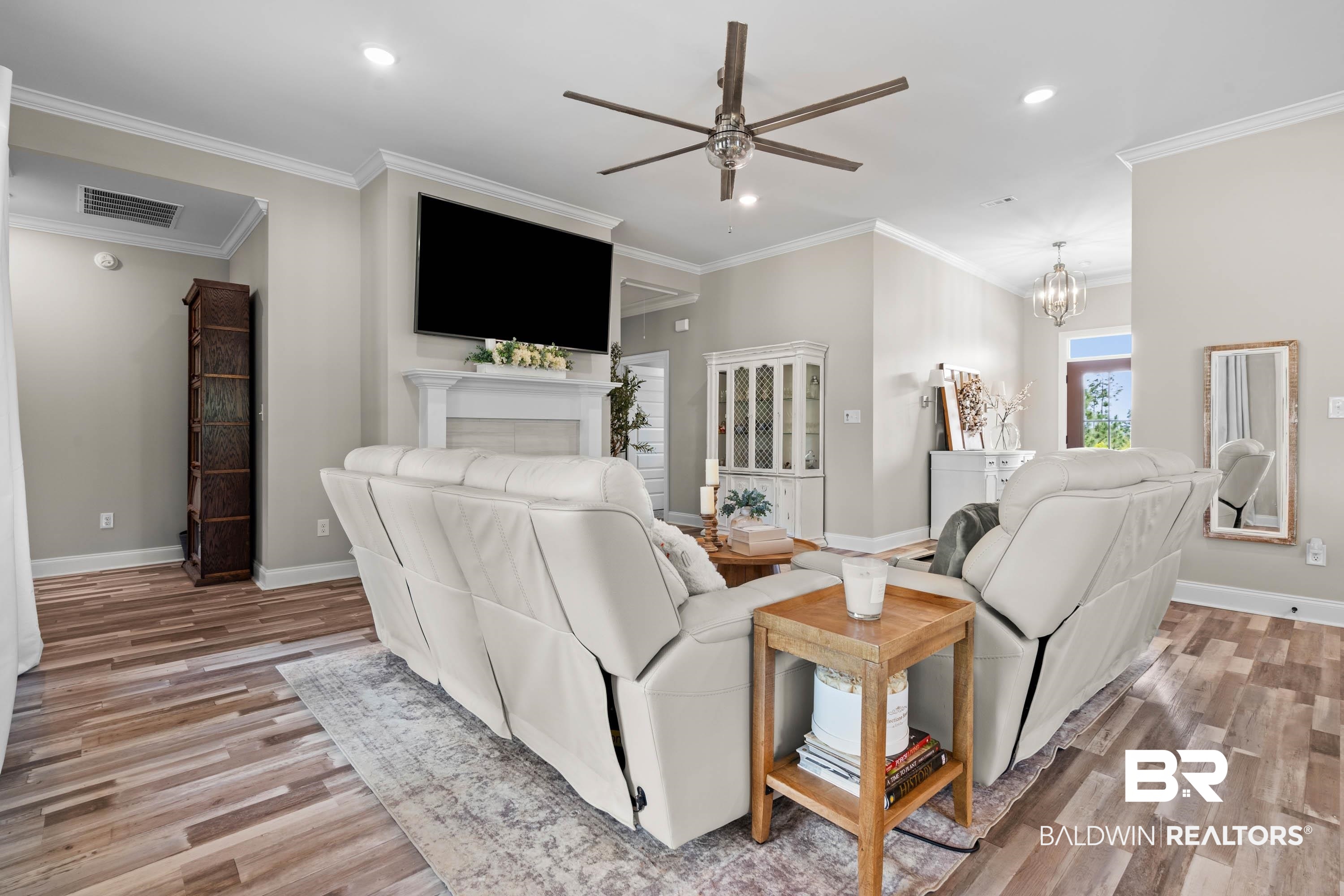 7150 Powell Road, Unit LOT 6A Eight Mile, AL 36613 - Photo 5 of 35 Living room with a ceiling fan, crown molding, light wood-style flooring, suspended lighting, and a fireplace