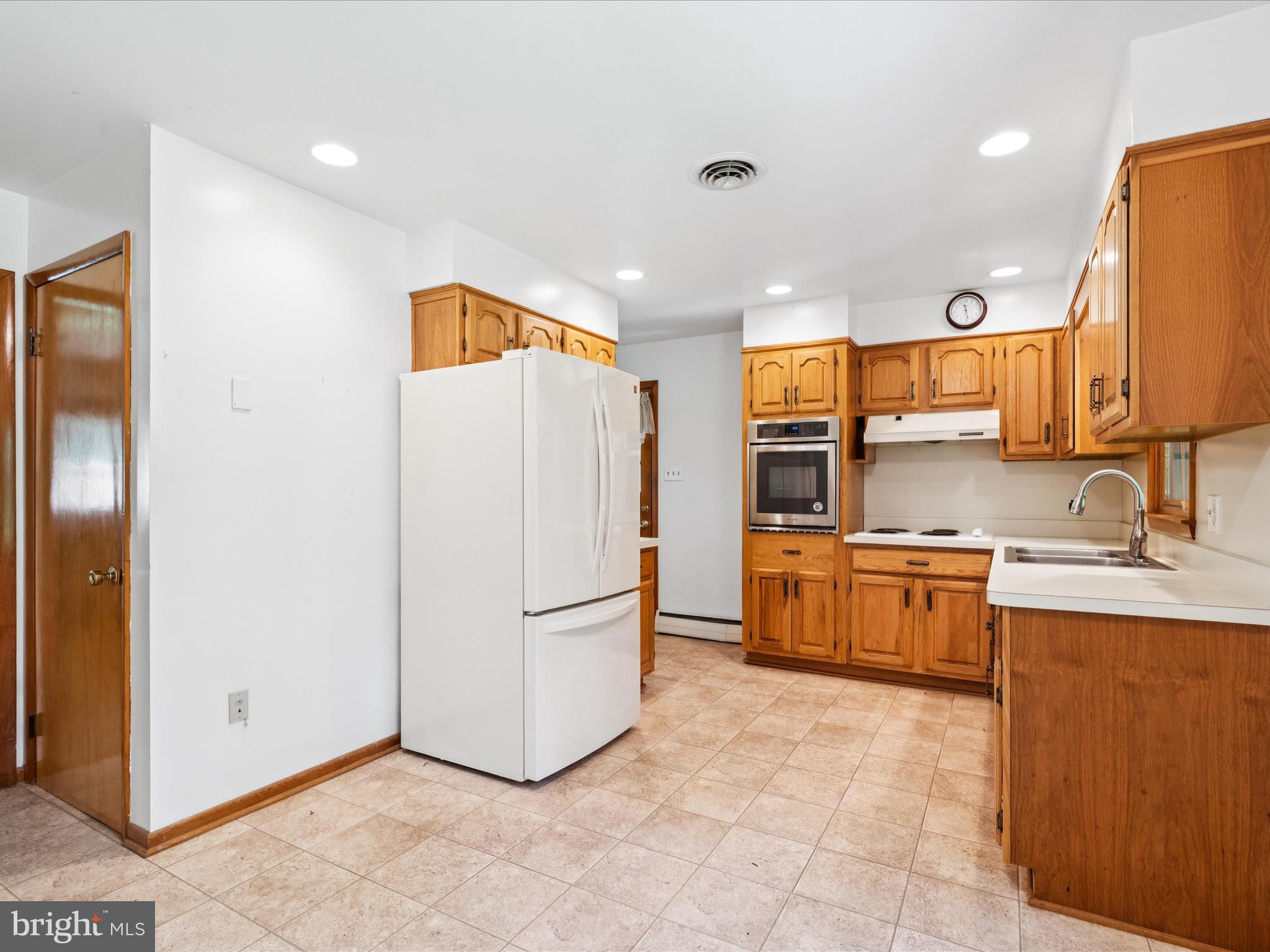 5149 Shookstown Road Frederick, MD 21702 - Photo 12 of 44 a kitchen with stainless steel appliances granite countertop a refrigerator and a stove top oven