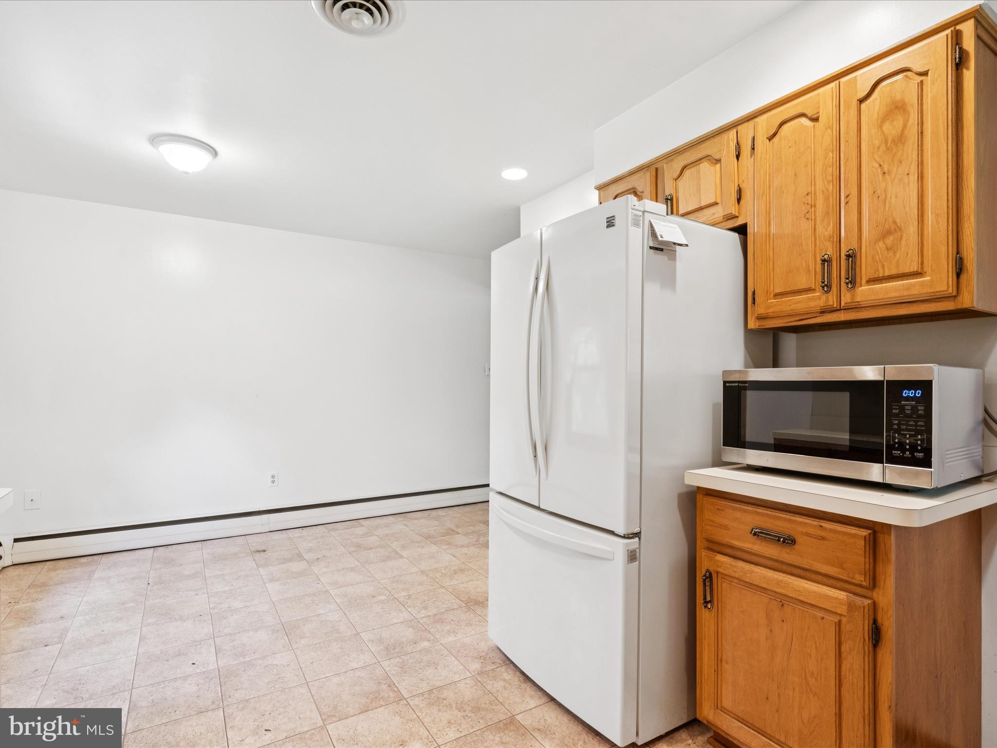 5149 Shookstown Road Frederick, MD 21702 - Photo 16 of 44 a white refrigerator freezer and a microwave in a kitchen
