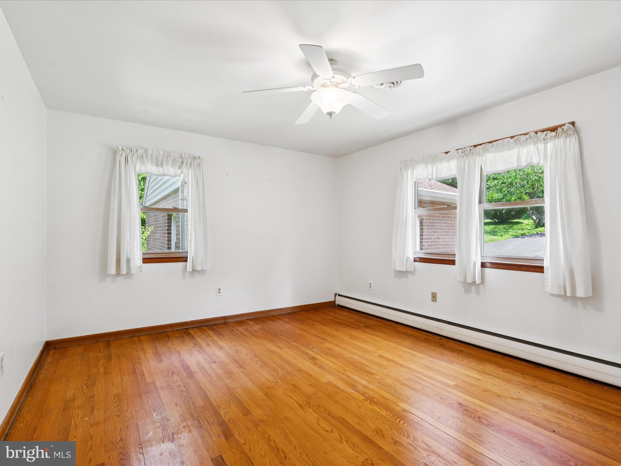 5149 Shookstown Road Frederick, MD 21702 - Photo 18 of 44 a view of an empty room with wooden floor and a window