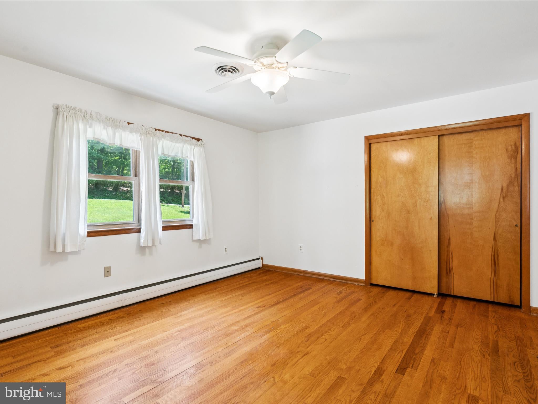 5149 Shookstown Road Frederick, MD 21702 - Photo 19 of 44 an empty room with wooden floor and windows