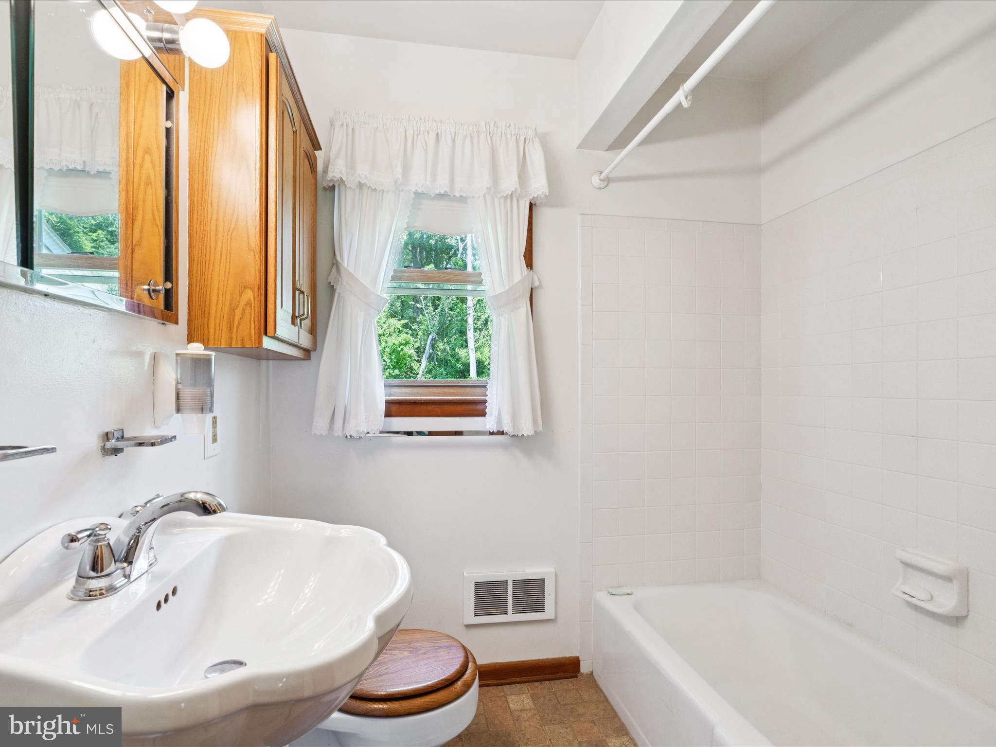 5149 Shookstown Road Frederick, MD 21702 - Photo 20 of 44 a bathroom with a tub a sink and a window