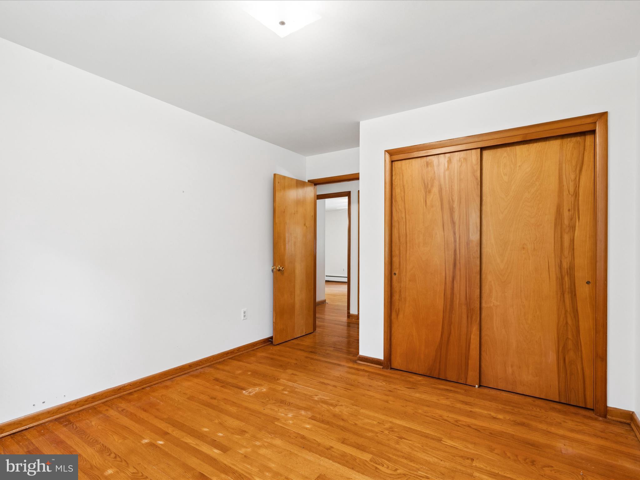 5149 Shookstown Road Frederick, MD 21702 - Photo 22 of 44 a view of an empty room with wooden floor and a window