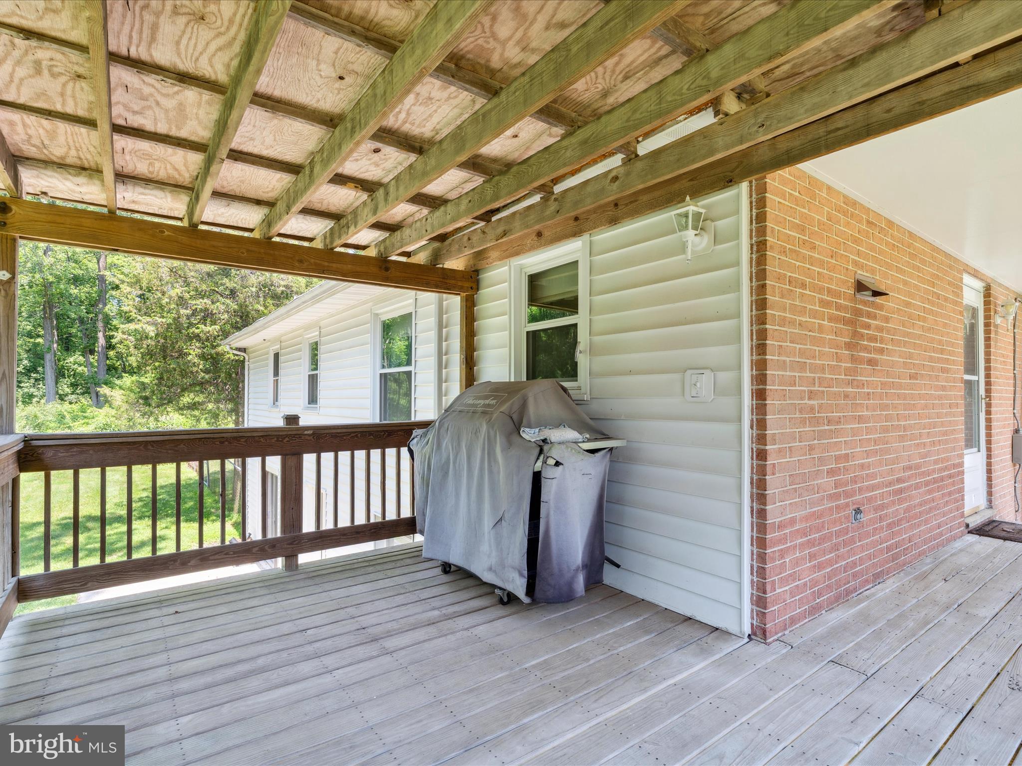 5149 Shookstown Road Frederick, MD 21702 - Photo 33 of 44 a view of a porch with wooden floor and iron stairs