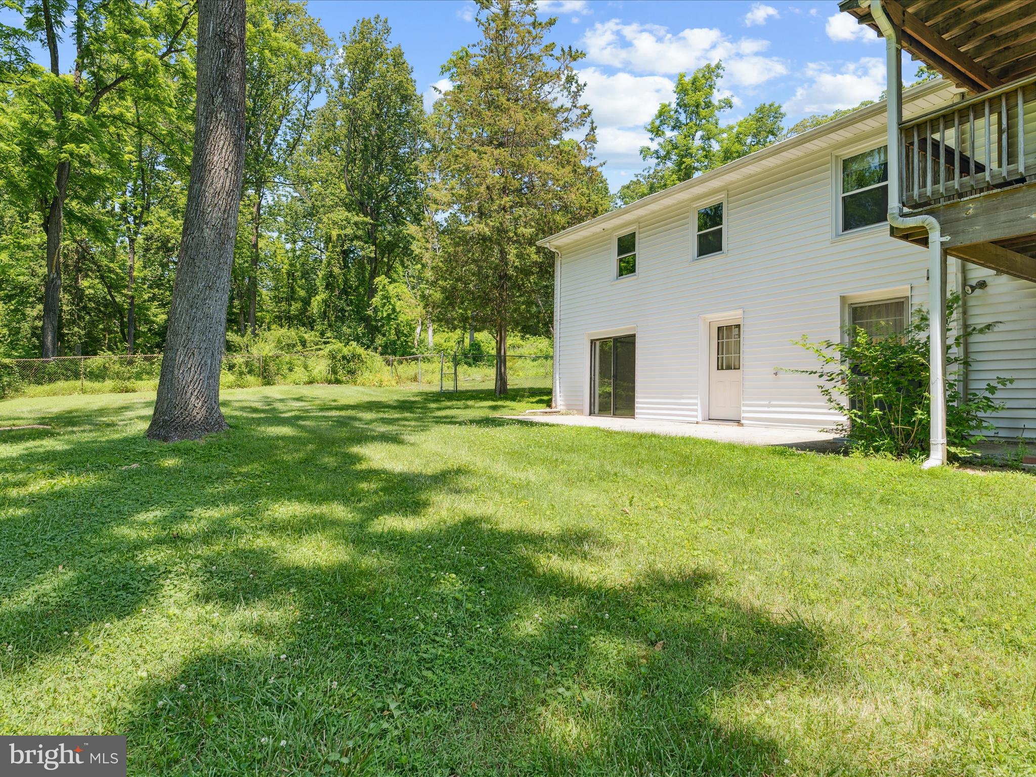5149 Shookstown Road Frederick, MD 21702 - Photo 37 of 44 a view of a backyard with plants and large tree