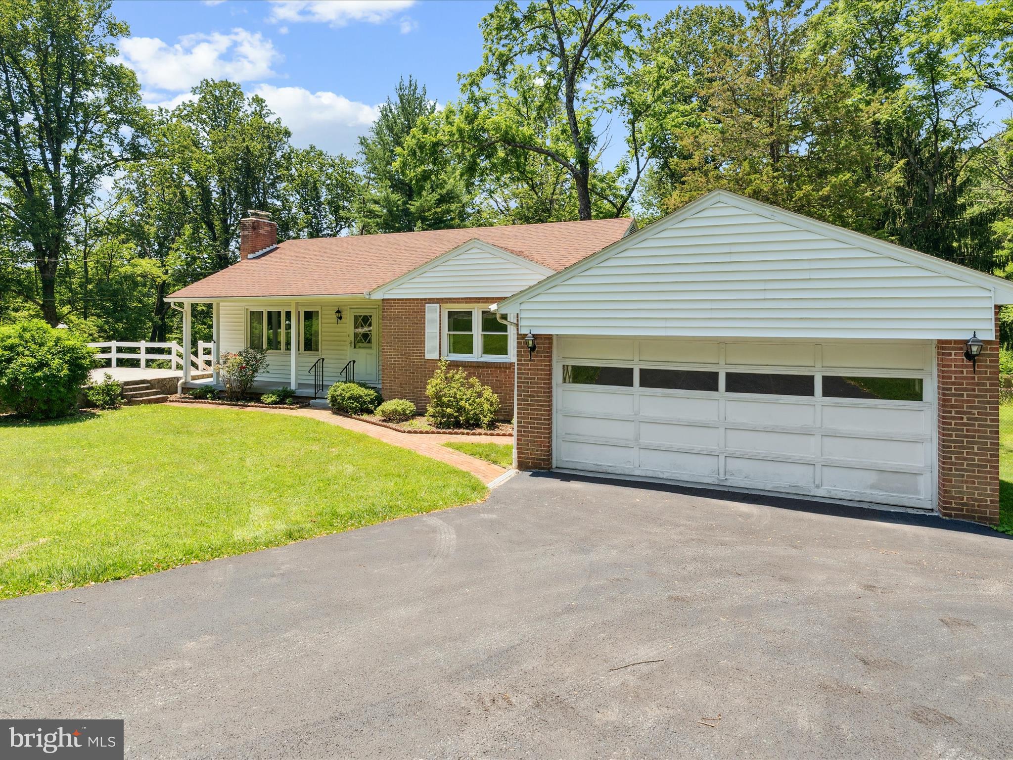 5149 Shookstown Road Frederick, MD 21702 - Photo 4 of 44 a front view of a house with a yard and garage
