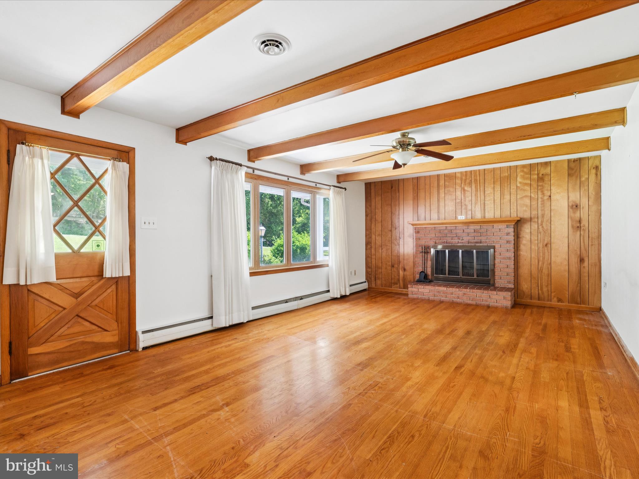 5149 Shookstown Road Frederick, MD 21702 - Photo 9 of 44 a view of an empty room with a window and wooden floor