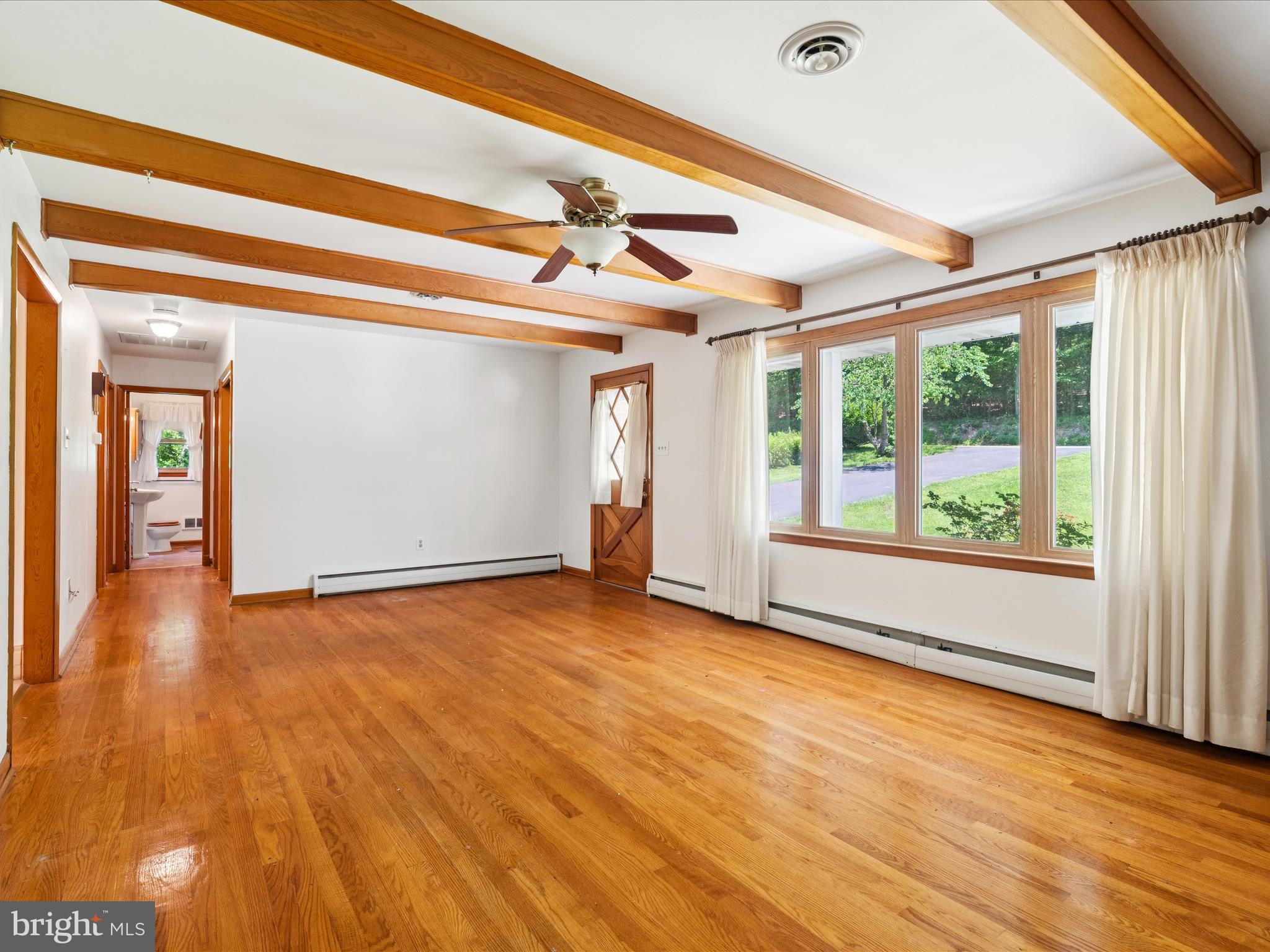 5149 Shookstown Road Frederick, MD 21702 - Photo 10 of 44 a view of an empty room with wooden floor and a window