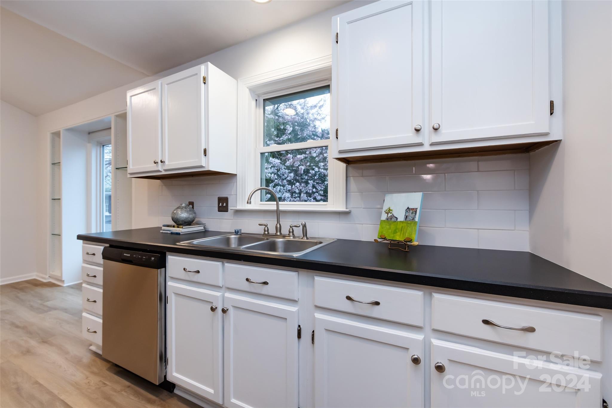 430 Queens Road, Unit 231 Charlotte, NC 28207 - Photo 11 of 23 a kitchen with stainless steel appliances white cabinets and a sink
