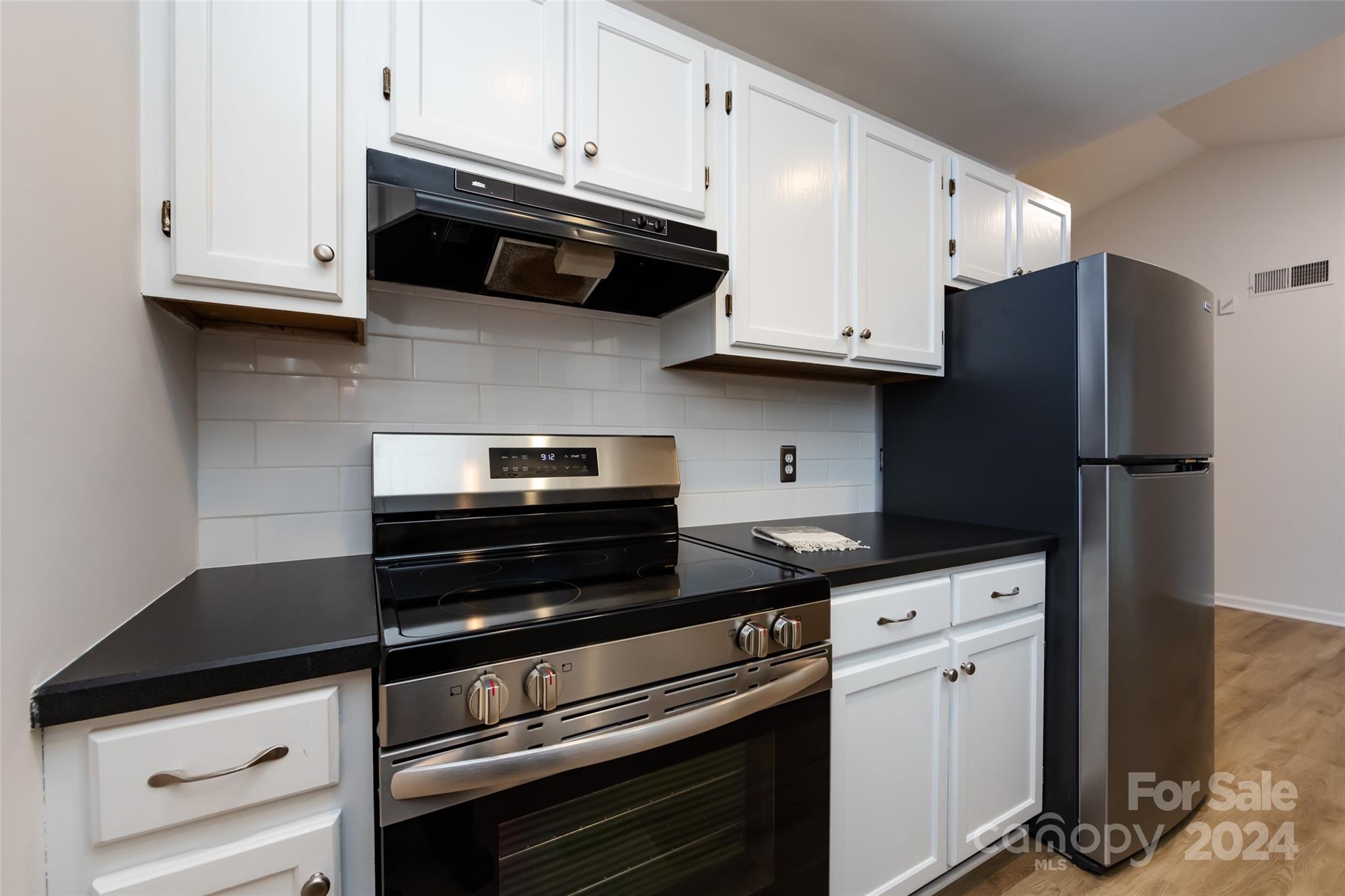 430 Queens Road, Unit 231 Charlotte, NC 28207 - Photo 12 of 23 a kitchen with granite countertop cabinets and steel stainless steel appliances