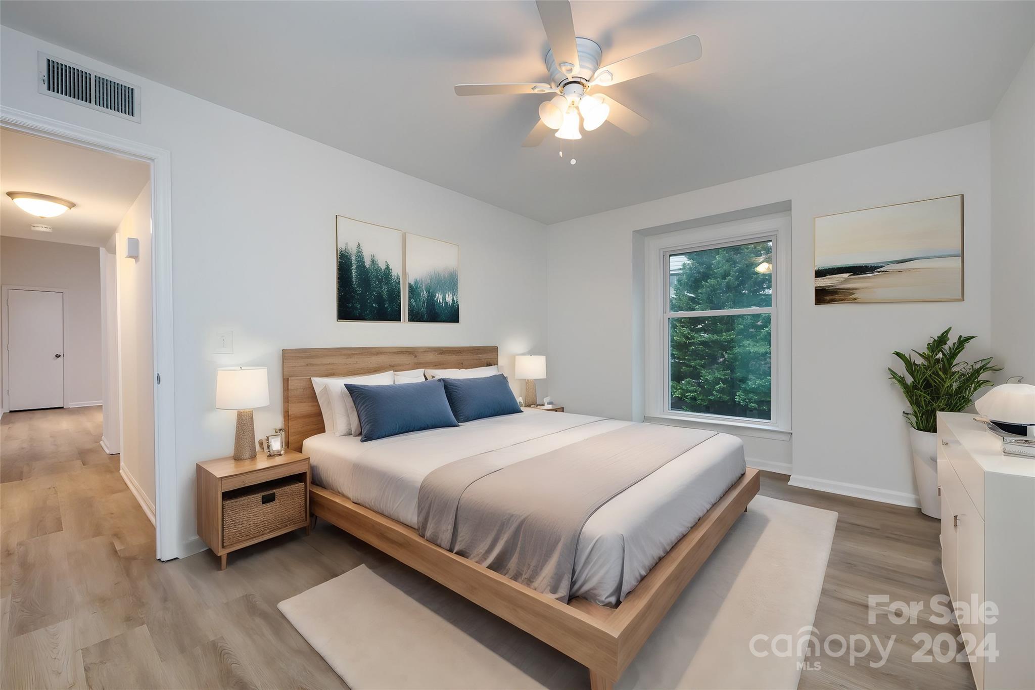 430 Queens Road, Unit 231 Charlotte, NC 28207 - Photo 13 of 23 a bedroom with a large bed and a window