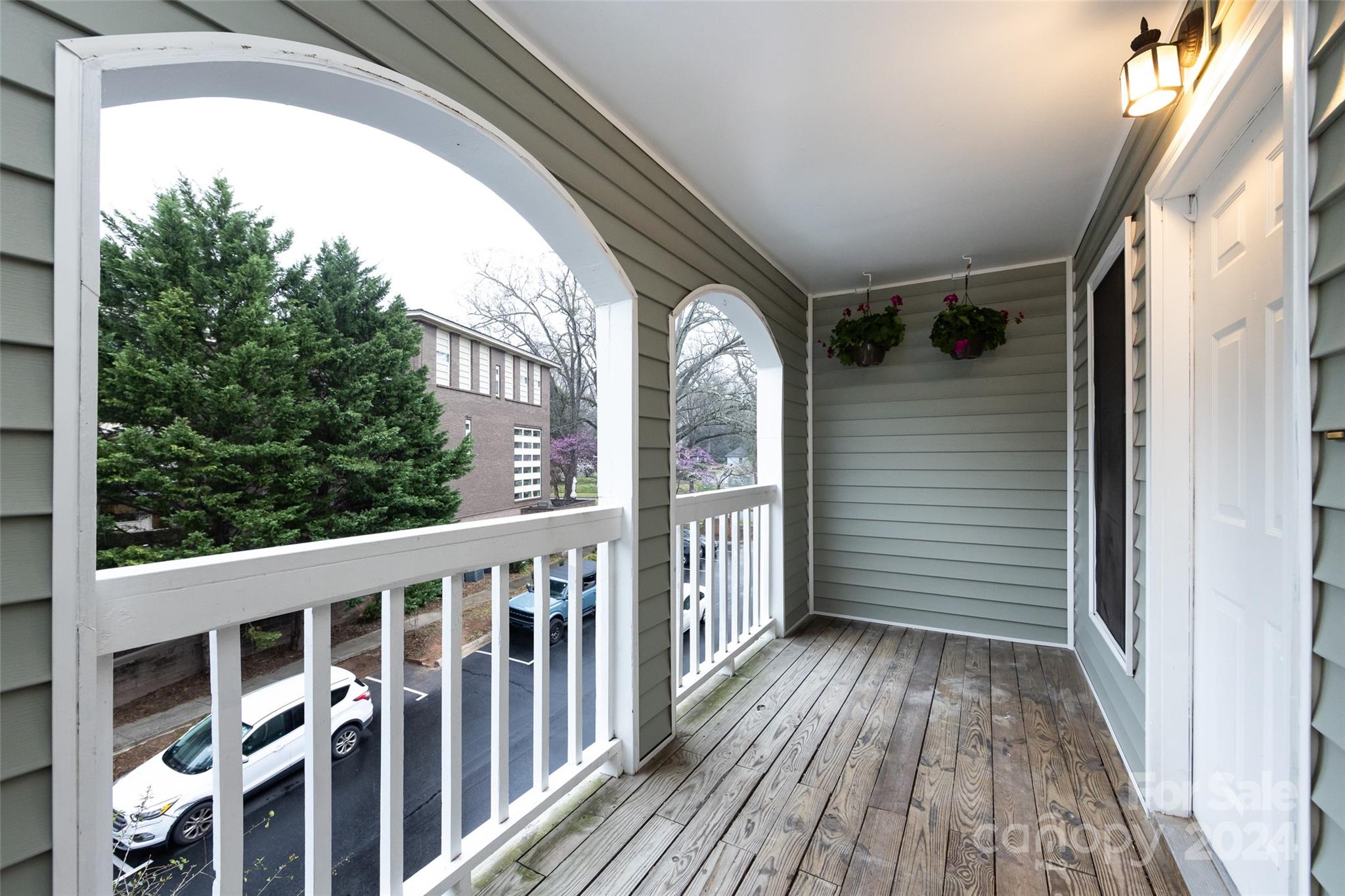 430 Queens Road, Unit 231 Charlotte, NC 28207 - Photo 4 of 23 a view of a balcony with wooden floor