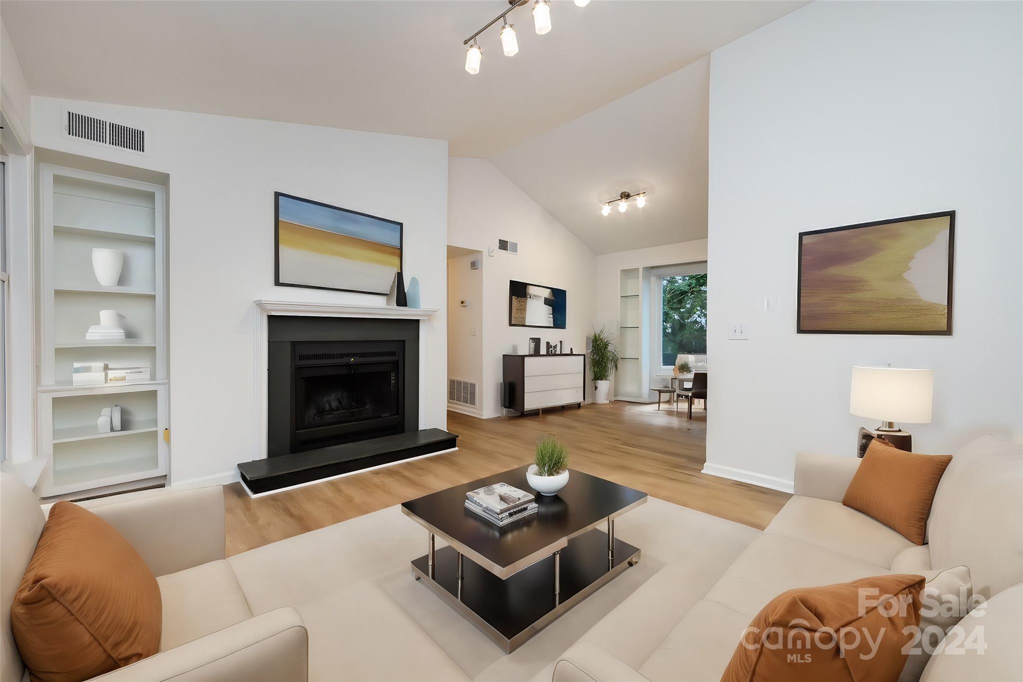 430 Queens Road, Unit 231 Charlotte, NC 28207 - Photo 5 of 23 a living room with furniture and a fireplace