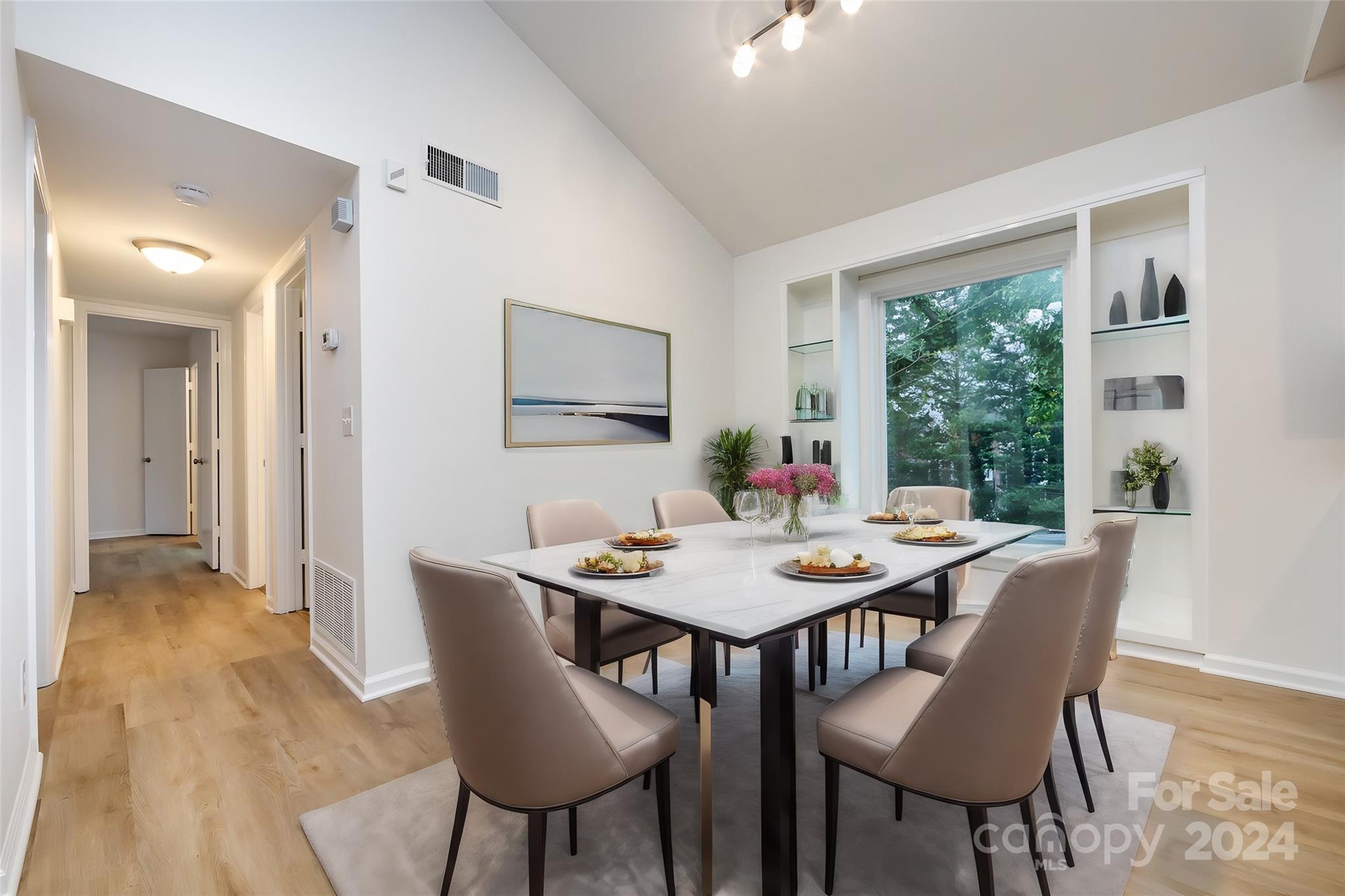 430 Queens Road, Unit 231 Charlotte, NC 28207 - Photo 7 of 23 a dining room with furniture a rug and wooden floor