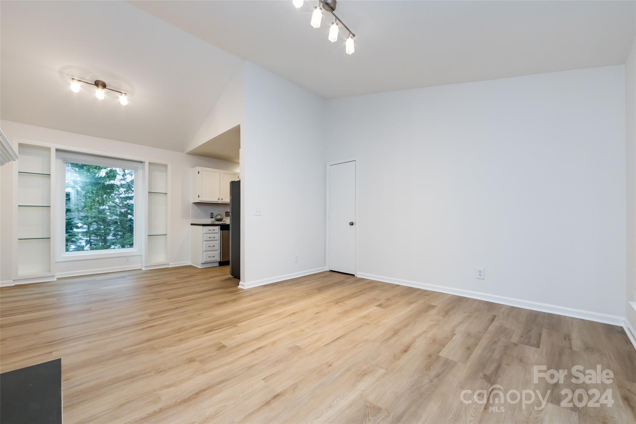 430 Queens Road, Unit 231 Charlotte, NC 28207 - Photo 9 of 23 wooden floor in an empty room with a window