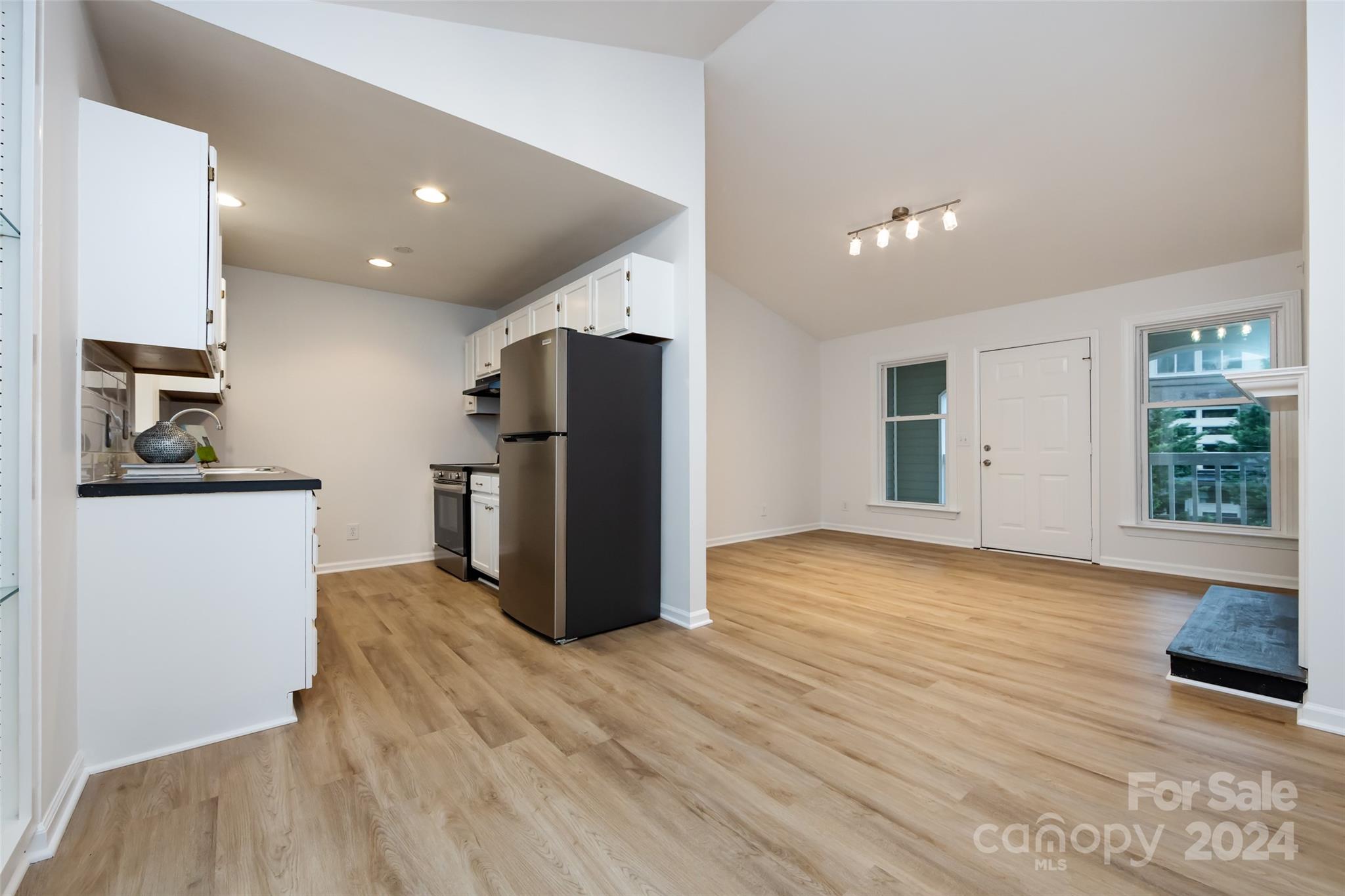 430 Queens Road, Unit 231 Charlotte, NC 28207 - Photo 10 of 23 a view of a kitchen with refrigerator and wooden floor