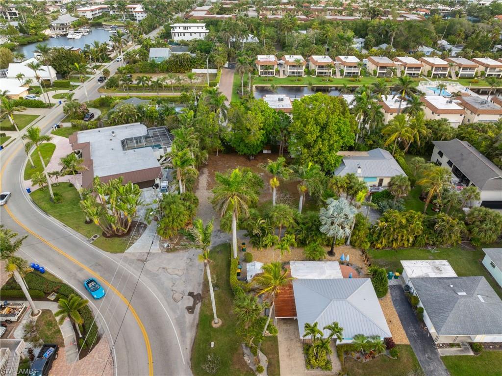 1205 Sandpiper Street Naples, FL 34102 - Photo 3 of 8 an aerial view of a house with a yard and lake view in back