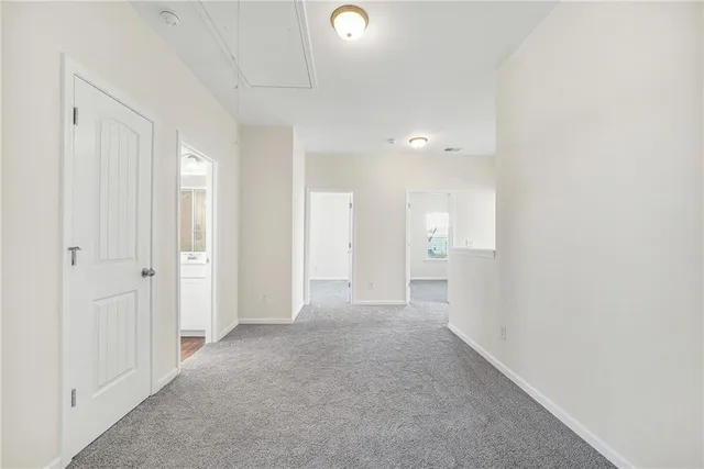 a view of a hallway with wooden shelves