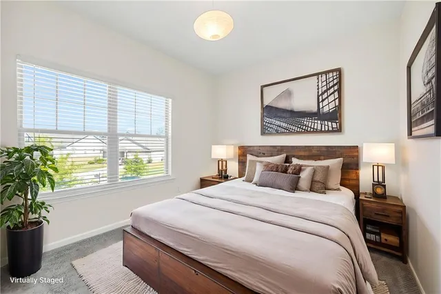 a bedroom with bed and a window