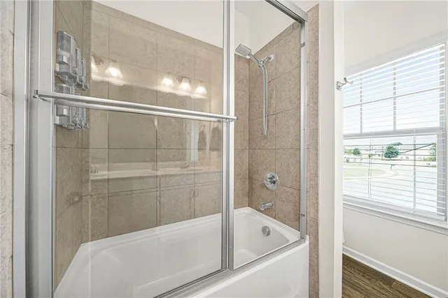 a bathroom with a bathtub and a shower