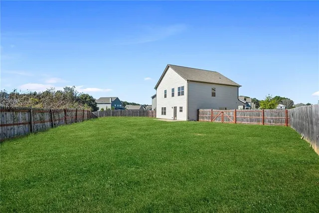a view of a house with a yard and sitting area
