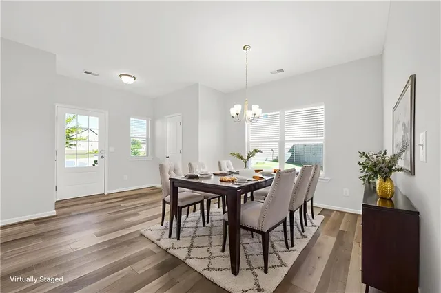 a view of a dining room with furniture and window