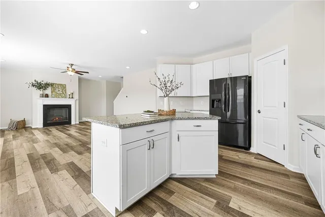 a kitchen with a refrigerator sink and cabinets