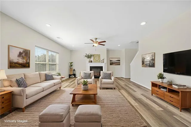 a living room with furniture flat screen tv and a fireplace