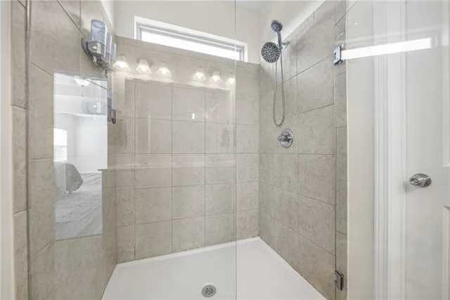 a bathroom with a shower and a mirror