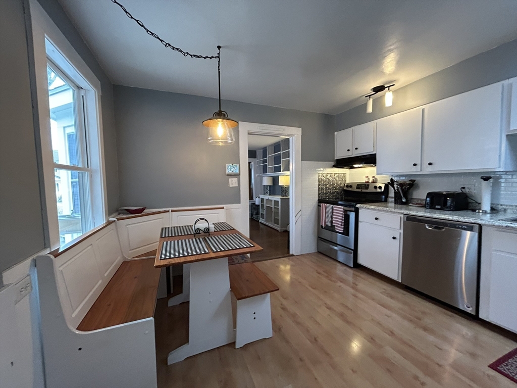 32 Parker Street, Unit 1 Lexington, MA 02421 - Photo 8 of 20 a kitchen with kitchen island granite countertop a stove and a sink