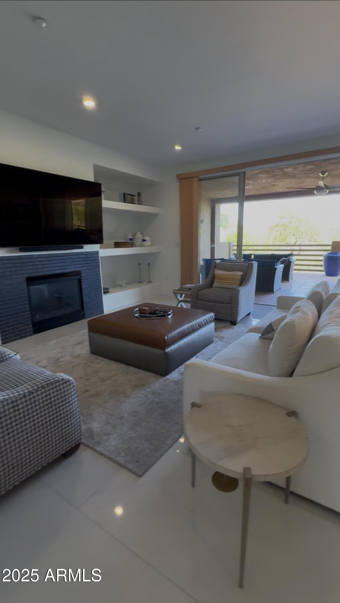 10222 East Southwind Lane, Unit 1009 Scottsdale, AZ 85262 - Photo 12 of 44 a living room with furniture and a flat screen tv