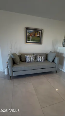 a living room with furniture and a lamp