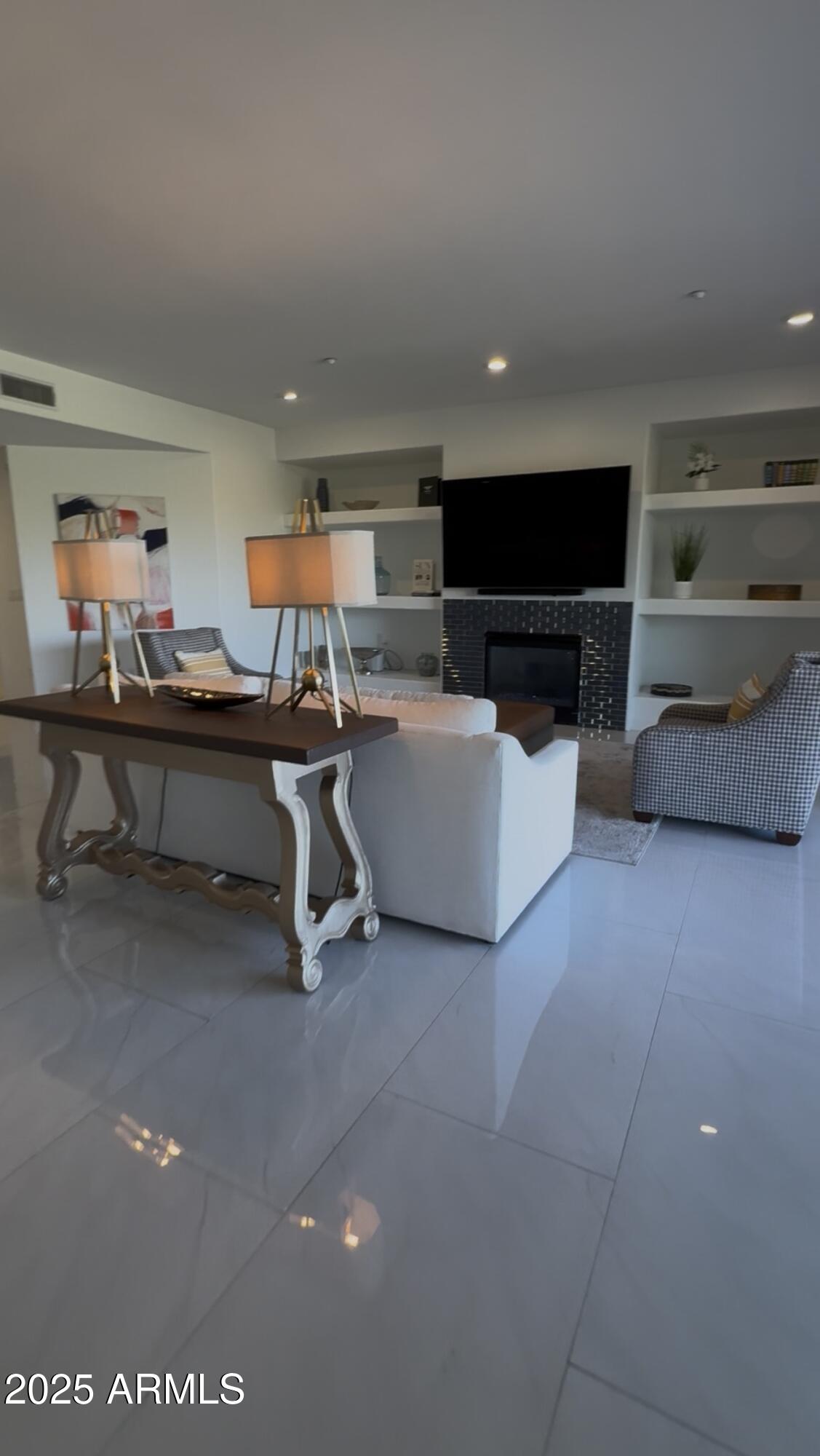 10222 East Southwind Lane, Unit 1009 Scottsdale, AZ 85262 - Photo 15 of 44 a view of a livingroom with furniture and a flat screen tv