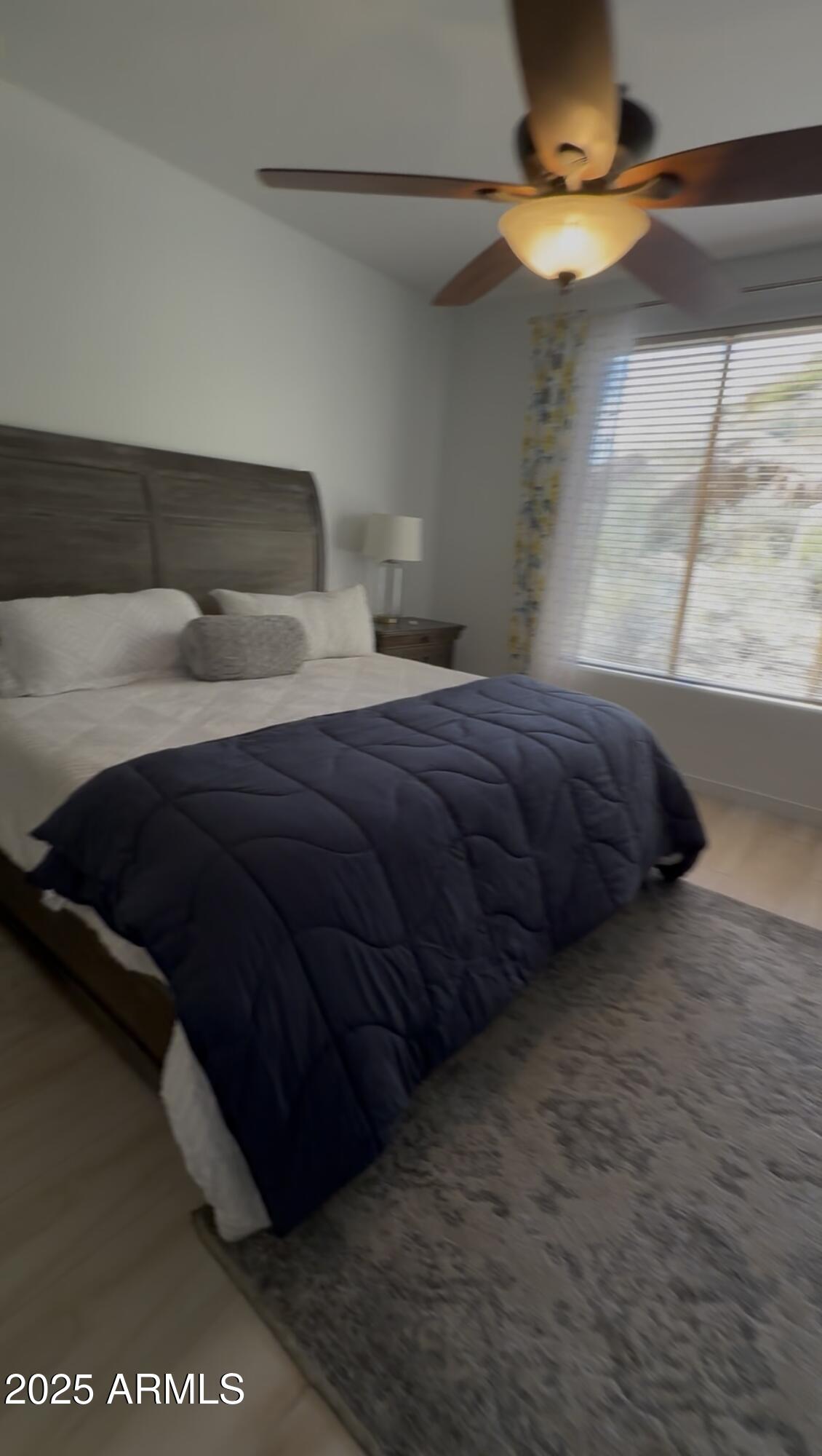 10222 East Southwind Lane, Unit 1009 Scottsdale, AZ 85262 - Photo 22 of 44 a bedroom with a bed and a window