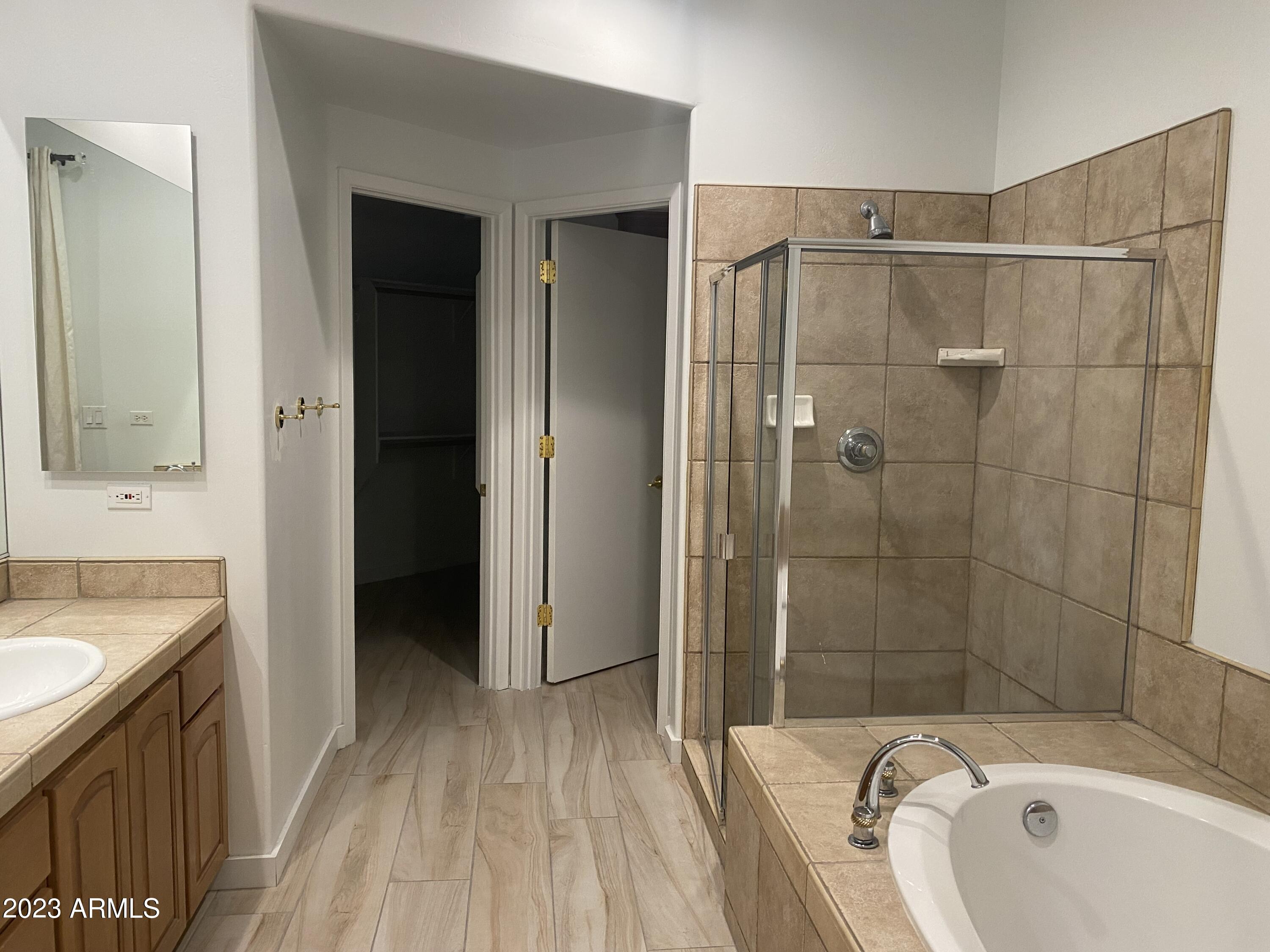 10222 East Southwind Lane, Unit 1009 Scottsdale, AZ 85262 - Photo 23 of 44 a bathroom with a sink a mirror and a bathtub