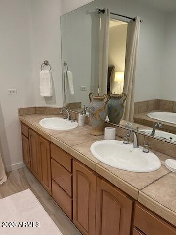 10222 East Southwind Lane, Unit 1009 Scottsdale, AZ 85262 - Photo 26 of 44 a bathroom with a granite countertop sink and a mirror