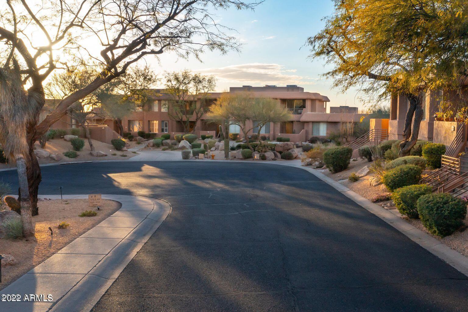 10222 East Southwind Lane, Unit 1009 Scottsdale, AZ 85262 - Photo 31 of 44 a city street lined with buildings and trees