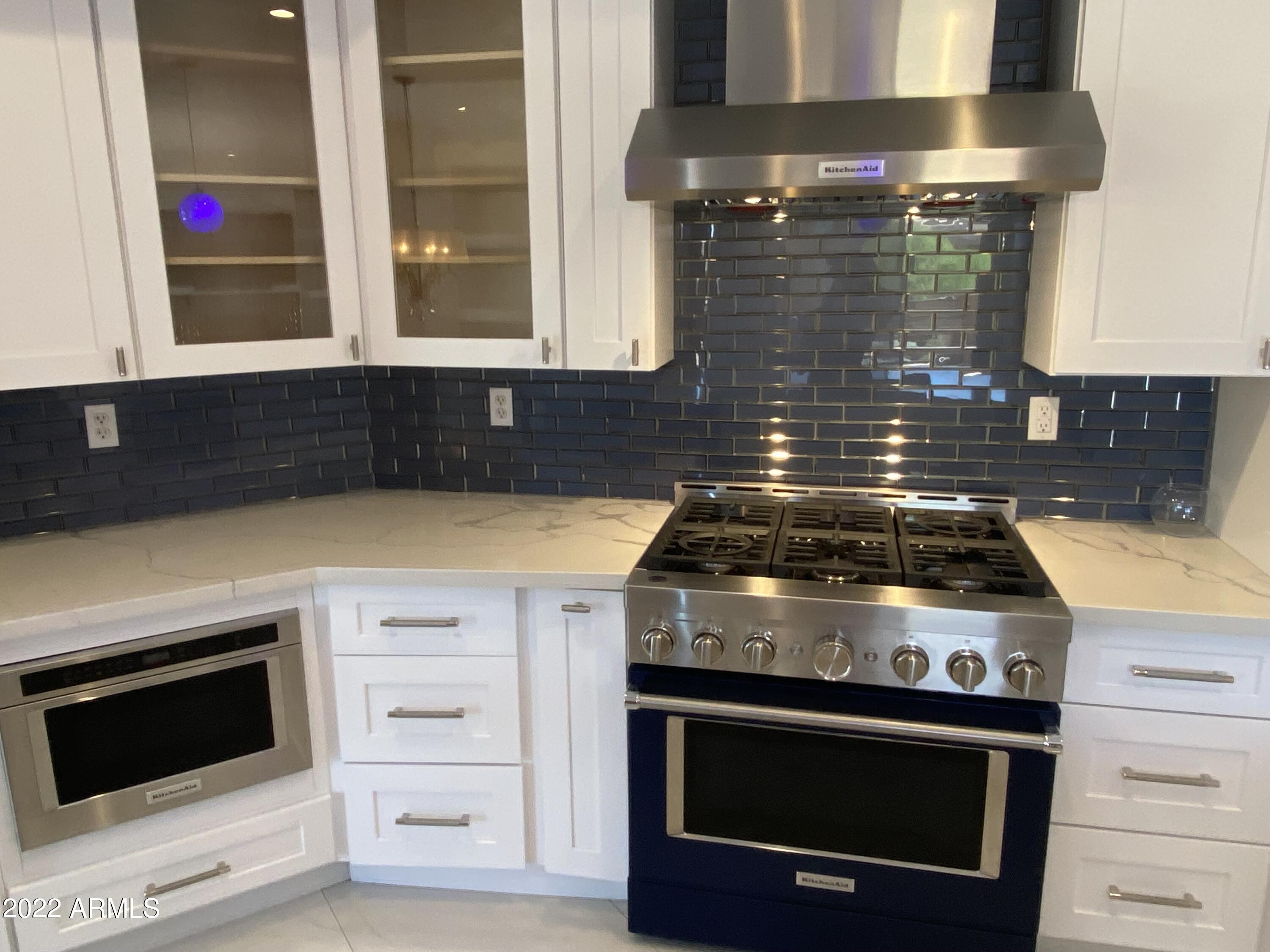 10222 East Southwind Lane, Unit 1009 Scottsdale, AZ 85262 - Photo 4 of 44 a stove top oven sitting inside of a kitchen