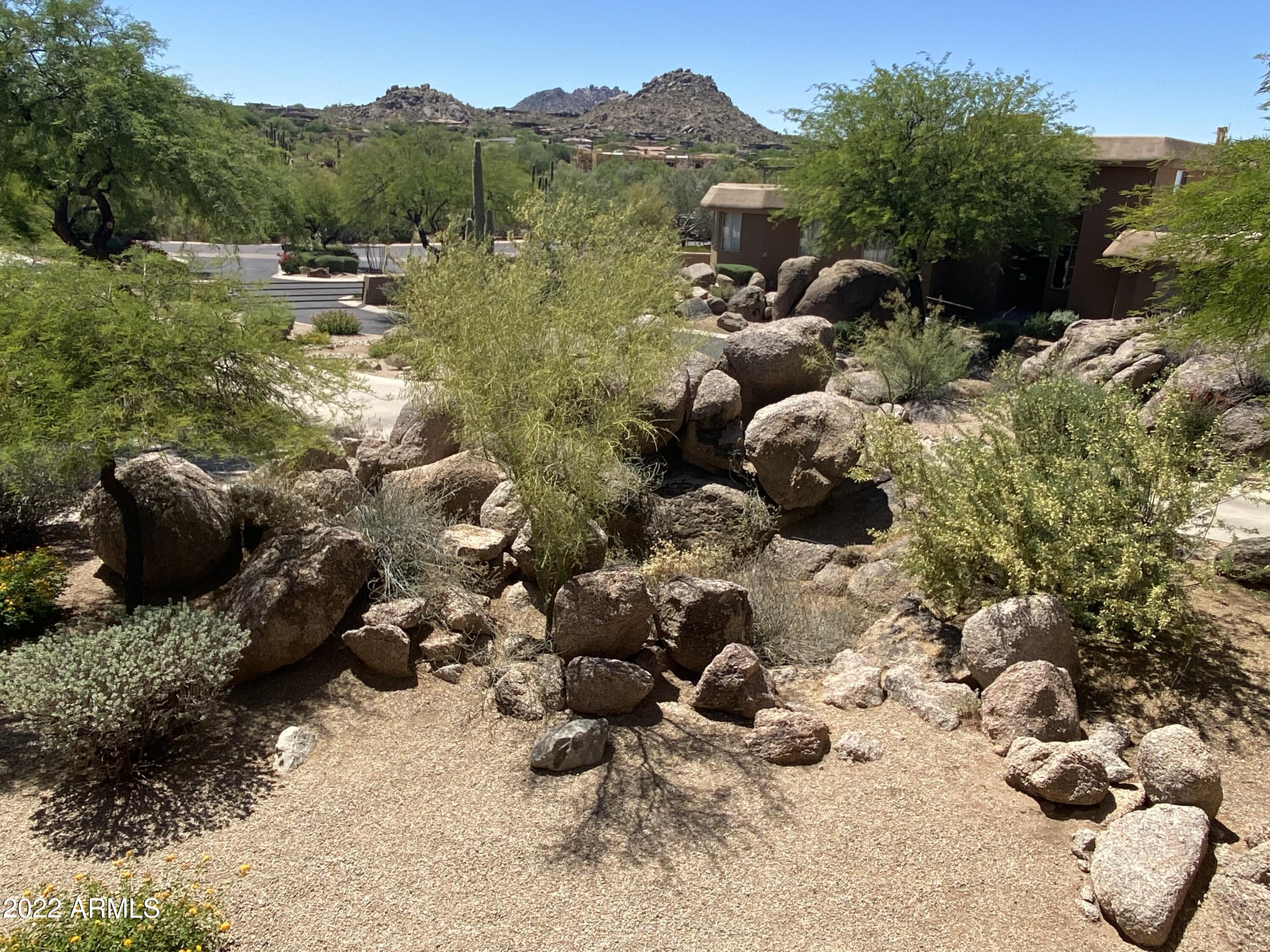 10222 East Southwind Lane, Unit 1009 Scottsdale, AZ 85262 - Photo 41 of 44 a backyard of a house with lots of green space