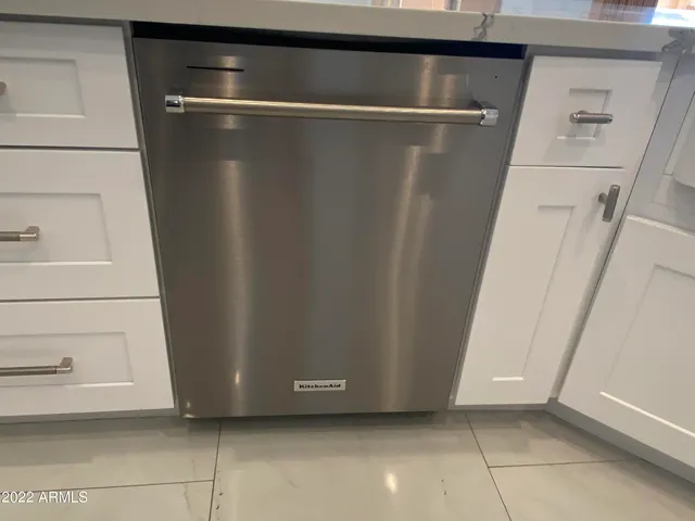 a kitchen with stainless steel appliances granite countertop a kitchen island a stove and a sink