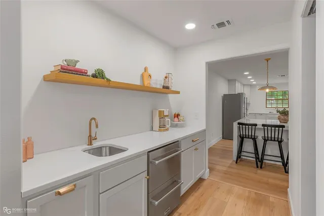 a kitchen with a sink cabinets and appliances